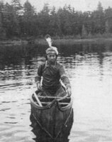 Ernie Benedict in Maniwaki birch bark canoe in Rainbow Lake Adirondacks. Approx. 1941