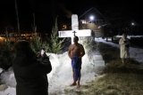 Russians take Epiphany dip in waters hit by oil spill