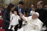 Pope Francis baptizes 21 babies in annual ceremony at the Sistine Chapel