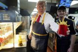 Trump mans a McDonald's fry station, holds drive-thru news conference