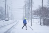 Powerful winter storm causes flight delays, slick roads, school closings