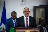 New Haiti PM sworn in as airliner hit by gunfire