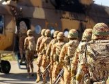 Iranian army soldiers conduct Parashoot drop during drill