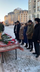 Kazakh people pay respect to plane crash victims by laying flowers at Azerbaijani embassy in Astana